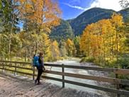 Hiker on the Leutasch bridge autumn forest