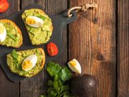 Bread with avocado and egg, tomatoes, parsley