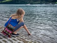 Girl splashing in the water with her hand