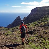Hikers with a view of rock formations and the sea at Las Playas bay on the island of El Hierro