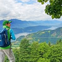 Hiker on the starry balcony near Döbriach with a view of Lake Millstättersee