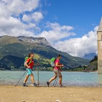 Hikers on the shore of lake Resia
