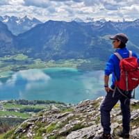 Wolgangsee panorama with hiker in the foreground