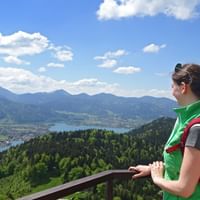 Hiker on the Riederstein with a view of Lake Tegernsee