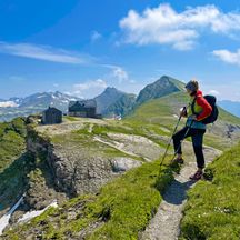 Hiker with a view of Hagener Hütte