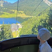 Young boy in the cable car to the mountain station at Traubenstein