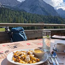 Kaiserschmarren on a mountain pasture, mountains in the background