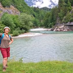 Hiker poses next to the Salzach on the pilgrimage route