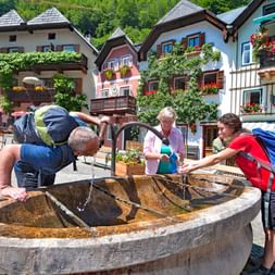 Hiking break at the water fountain in the heart of Hallstatt