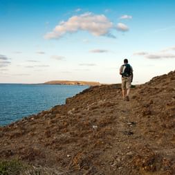 Hiker at a coastal path in Menorca