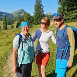 Hikers look forward to the alpine pasture