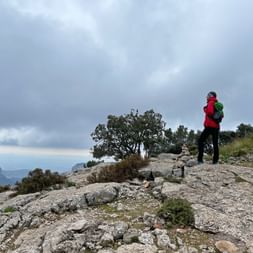 Hiker at the top of the Puig de l'Ofre