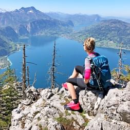 Attersee panoramic view hiker on rocks