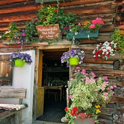 Blumenverziehrter Eingang zur Alm