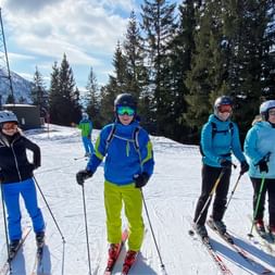 Four skiers on the piste