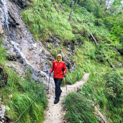 Hiker hikes through the Burggrabenklamm gorge on a narrow hiking trail