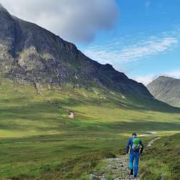 Hiker on the path through the Glen Coe Valley