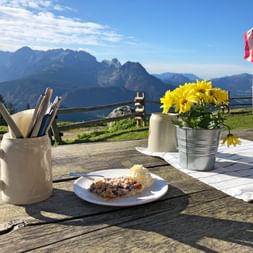 Eating cake on the terrace of an alpine hut on the Gosaukamm