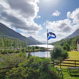 Fjord flag in front of a lake in Kinlochleven