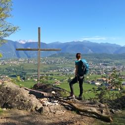 Hiker marvels at the panoramic view onto the Adige Valley