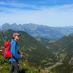 Hiker on the Augstenberg with the mountain panorama in the background