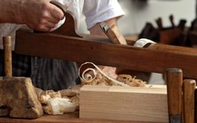 A carpenter's plane with sawdust