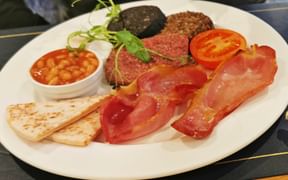 Typical local breakfast with bacon, baked beans and black pudding