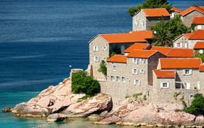 The island of Sveti Stefan with its typical stone houses and red-tiled roofs