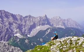 Wanderin mit Blick auf felsiges Bergmassiv