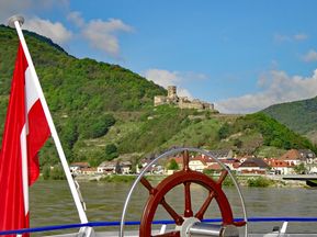 Boat cruise on the Danube with view of a ruin