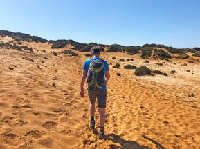Hiker walks along a sandy path