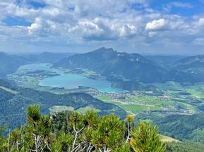 View from a mountain of the landscape with lake, mountains, clouds and sunshine