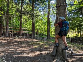 Hiker in the forest on the climbing course