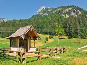 Alpine meadows with Hubertus chapel and mountain panorama