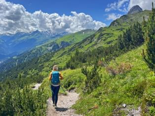 Wanderin auf dem Weg von Steeg nach Landeck mit einem herrlichen Bergpanorama