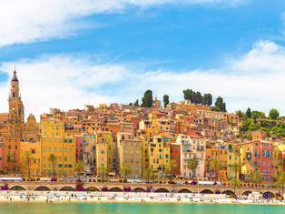 View over the sea to the colourful houses of the town of Menton on the Côte d'Azur