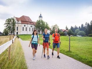 Three hikers at the beautiful Wieskirche