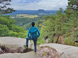 Hiker enjoy the view of Lilienstein from the Ochelwände