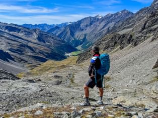Hiker enjoys the view of the Pfossental valley