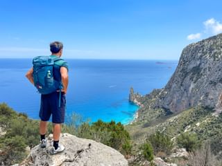 Hiker enjoys the view of the bay of Santa Maria di Navarese