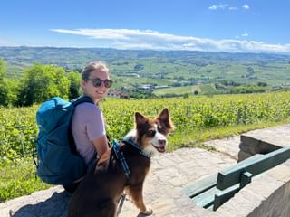 hiker and dog with a view of the Piedmont wine landscape