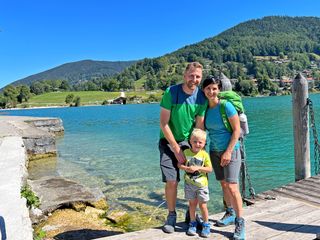 Hiker with son in front of wooden logs on the Bockerlbahnweg trail