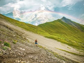 Hiking on the Alpschelegrat with a rainbow over Kandersteg