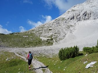 Hiker on stony hiking trail in the direction of Lafatscherjoch