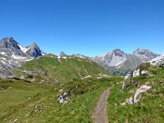 Hiking trail over the Alps, with a view over the mountains