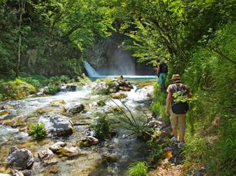 Hikers on the way to a waterfall in the northern Albanian Alps