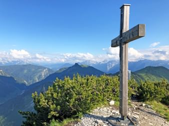 Summit cross with a view of the mountains
