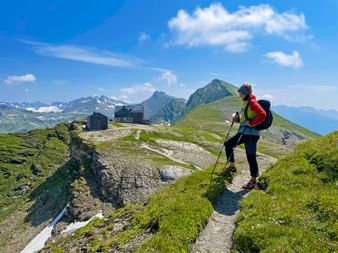 Hiker with a view of Hagener Hütte