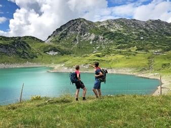 Hikers at the Formarinsee lake in Lech am Arlberg