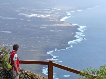 Hiker looks out over the coast of El Hierro